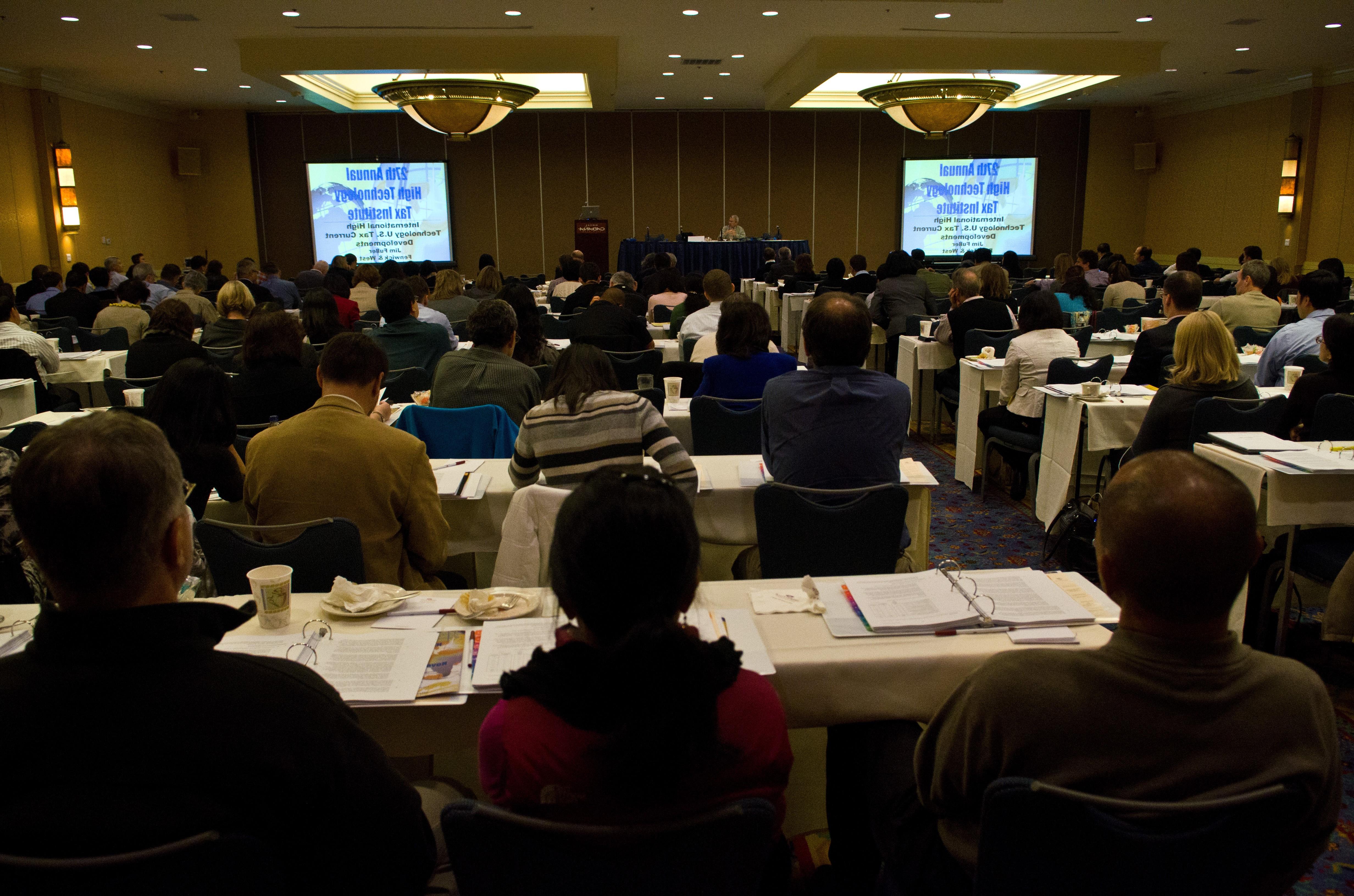 Image of tax professor speaking to group. 